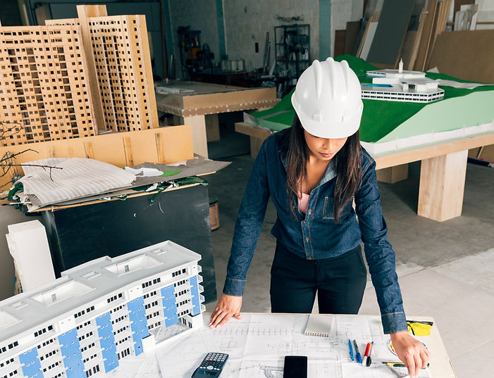 african-american-lady-safety-helmet-standing-near-model-building